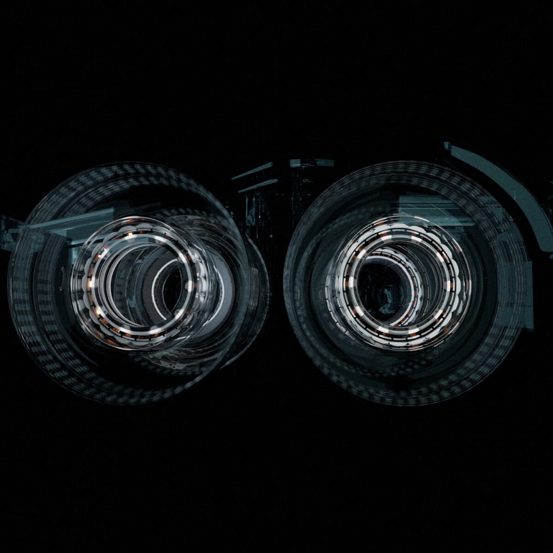 Abstract image showing two circular, symmetrical structures resembling camera lenses or futuristic machinery against a dark background. The circles have intricate, reflective patterns with a glowing effect.